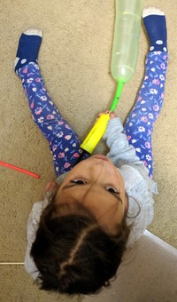 Olive blowing balloon