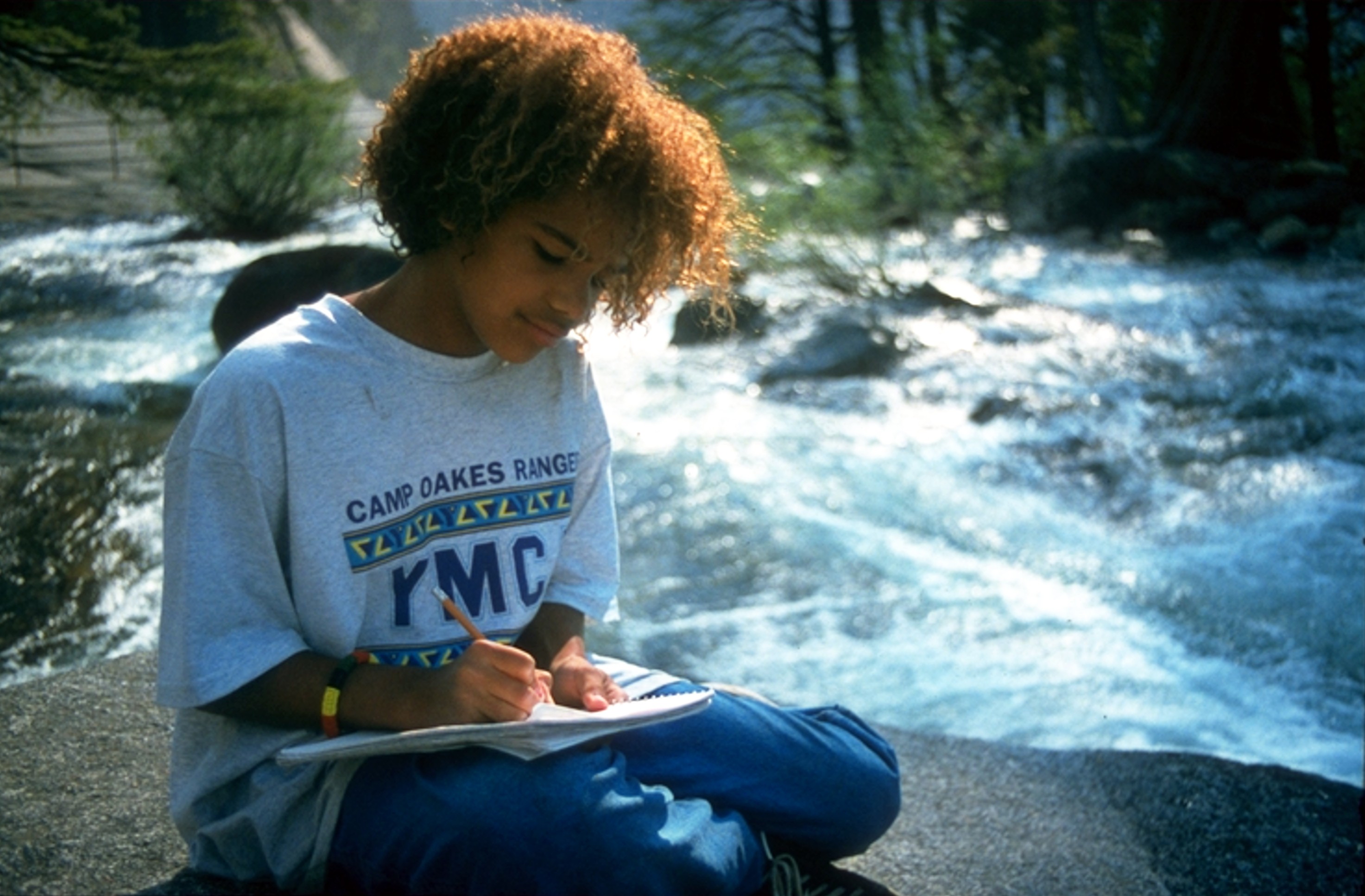 Summer writing at top of falls in Yosemite