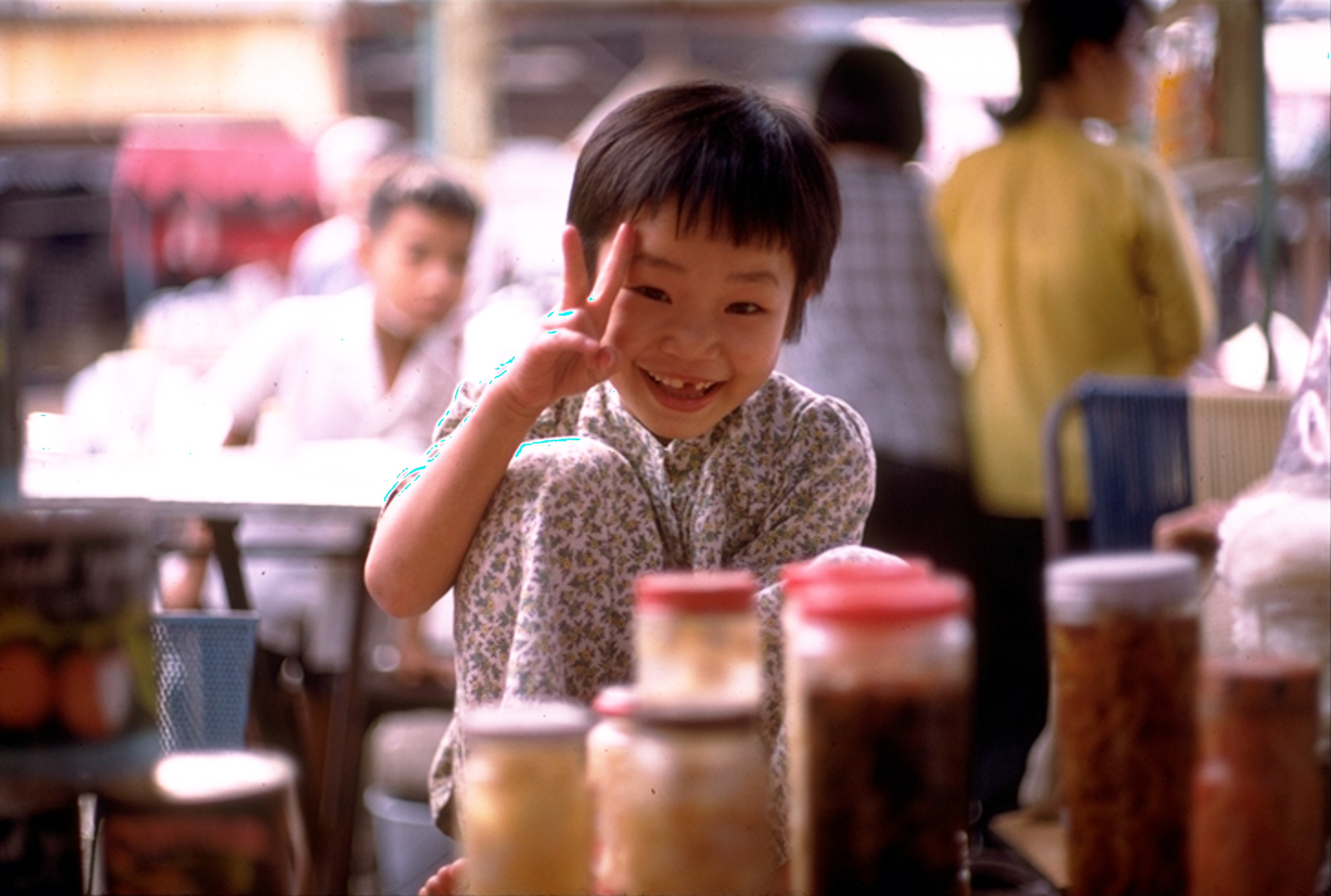 Vietnamese market girl imitating photographer 1970